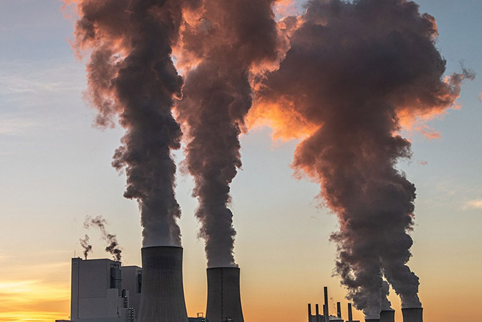 Smokestacks in low-angled sunlight