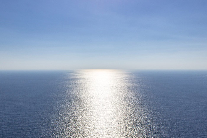 Sunlight reflection on smooth ocean surface