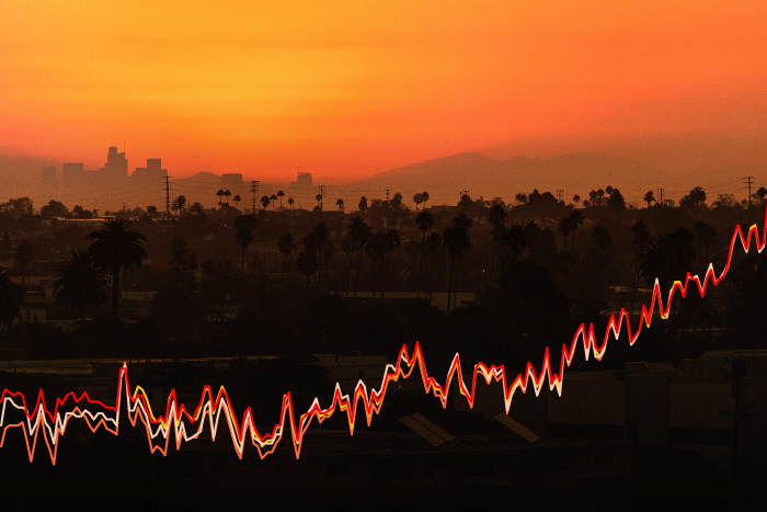 line graphs of global surface temperature over time overlaid on a sunset photo