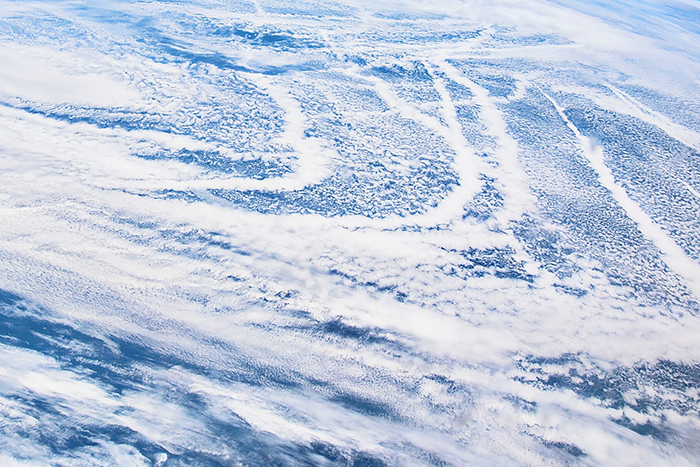 Contrails and clouds over ocean