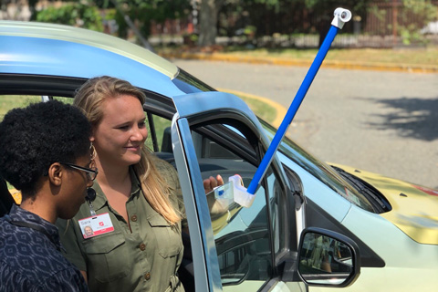 volunteers attach a temperature sensor to a car