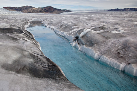 Photo of dirty ice surrounding a meltwater stream near the margin of the ice sheet.
