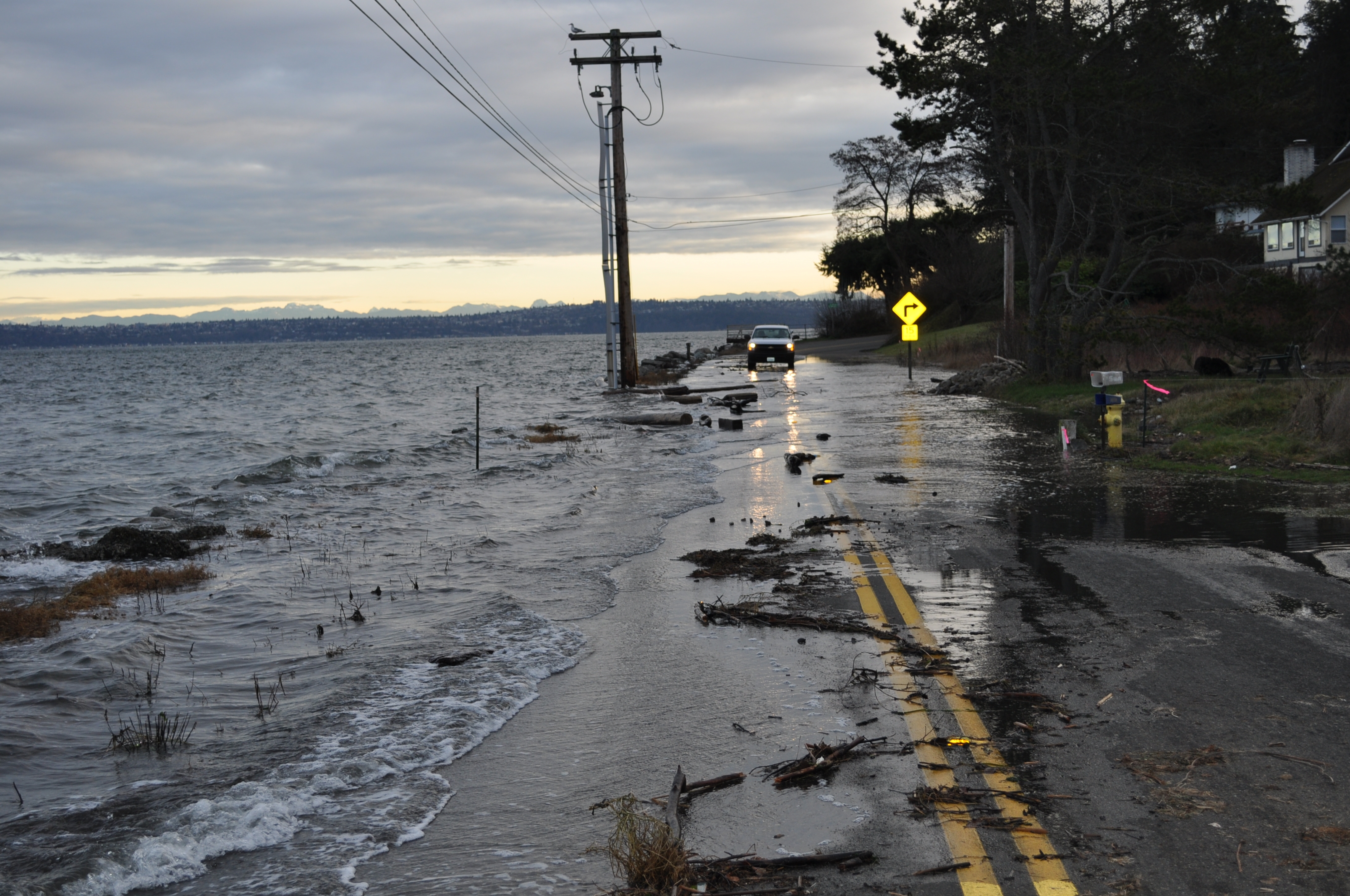 Photo of a truck navigating a road half covered by nuisance high-tide flooding from Puget Sound in Port Orchard, Washington, on January 6, 2010.