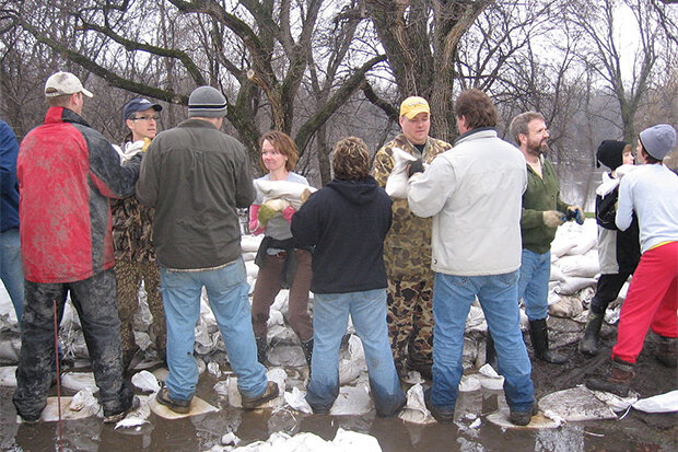 Line of people filling sandbags