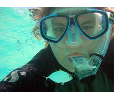 Caroline Rogers underwater in a scuba mask 